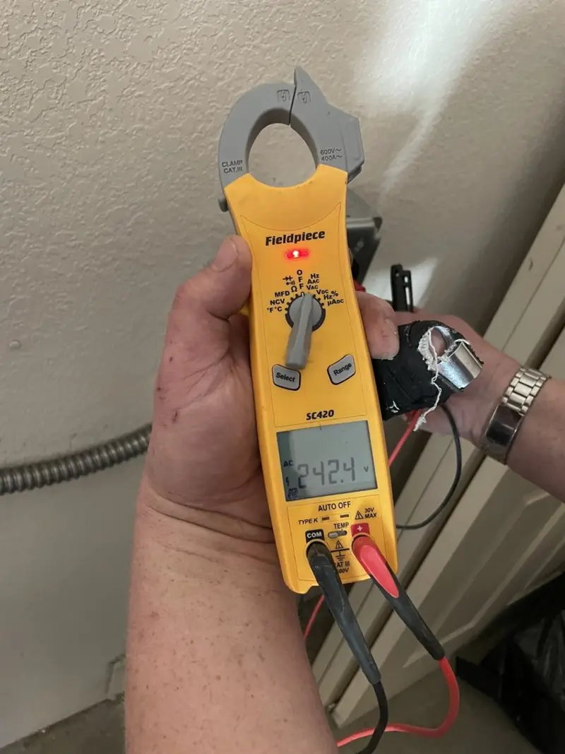 Voltage testing with clamp meter during Recessed Lighting Installation in Middlebury